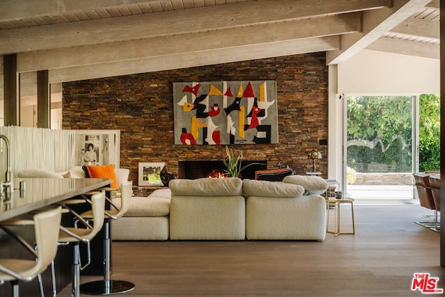 living room with hardwood / wood-style floors, vaulted ceiling with beams, wooden ceiling, and a fireplace