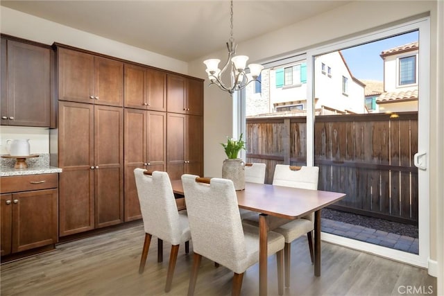 dining room featuring a chandelier and light wood-type flooring