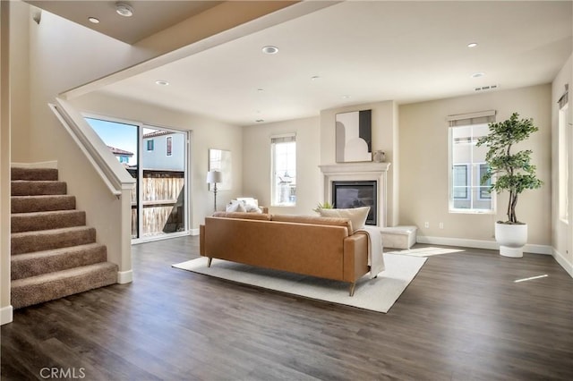 living room featuring stairway, dark wood-style floors, visible vents, baseboards, and recessed lighting