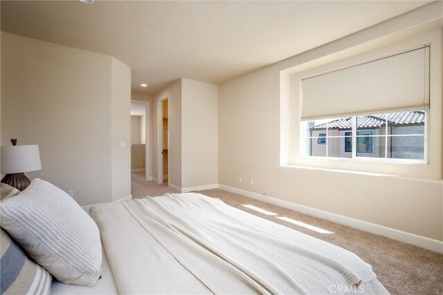 bedroom with recessed lighting, baseboards, and light colored carpet