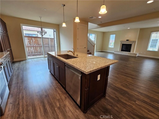 kitchen with a glass covered fireplace, dark wood-style floors, a sink, dark brown cabinets, and dishwasher