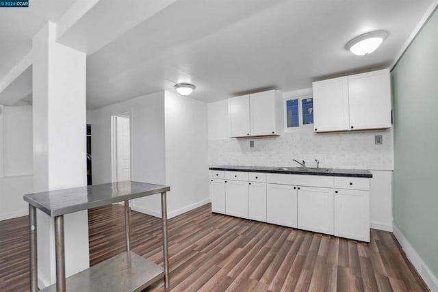 kitchen featuring white cabinets, backsplash, sink, and dark hardwood / wood-style flooring