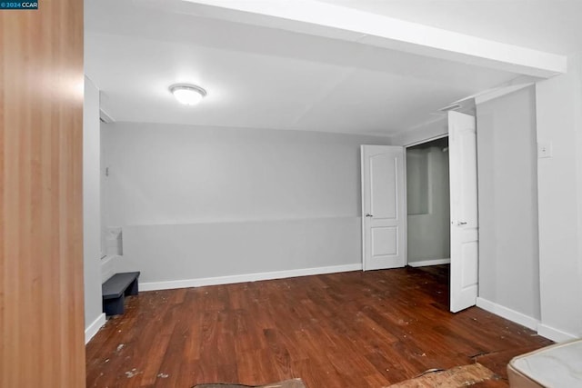 unfurnished bedroom with dark wood-type flooring