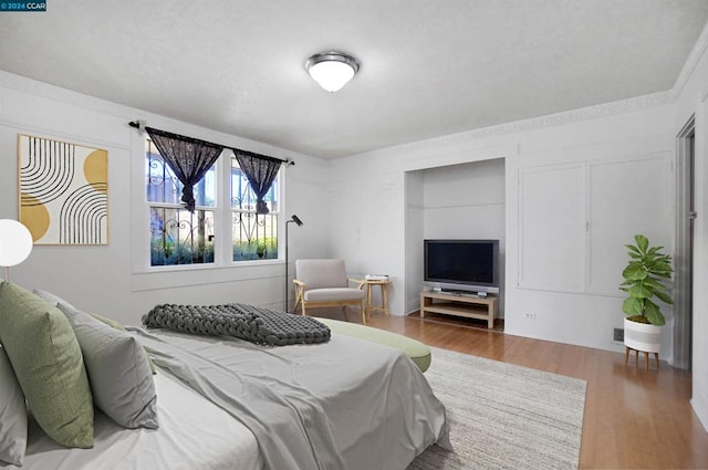 bedroom with hardwood / wood-style flooring