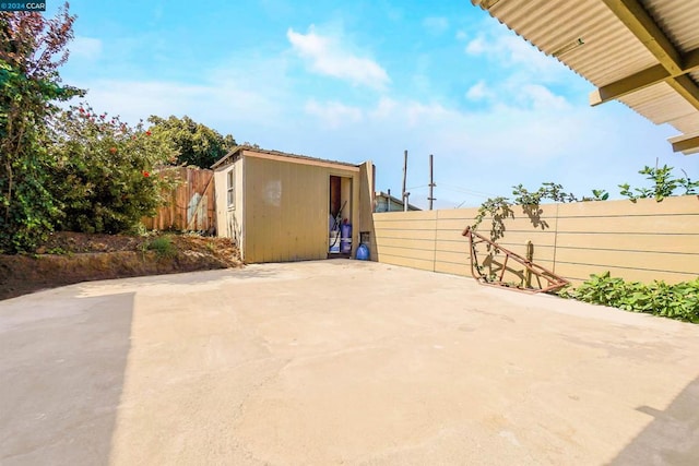 view of patio with a storage unit