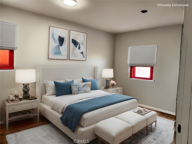 bedroom featuring wood finished floors and baseboards