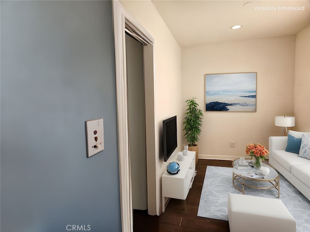 living room featuring recessed lighting, baseboards, and wood finished floors