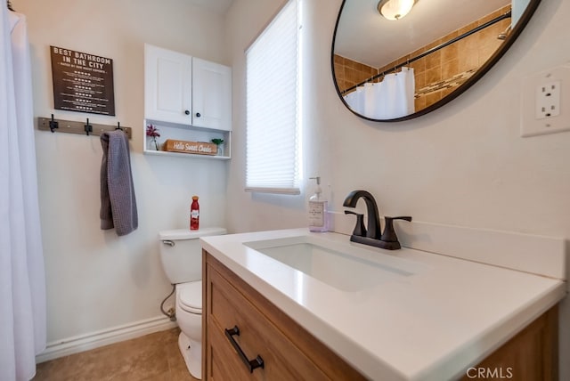 bathroom with a shower with curtain, vanity, toilet, and tile patterned floors