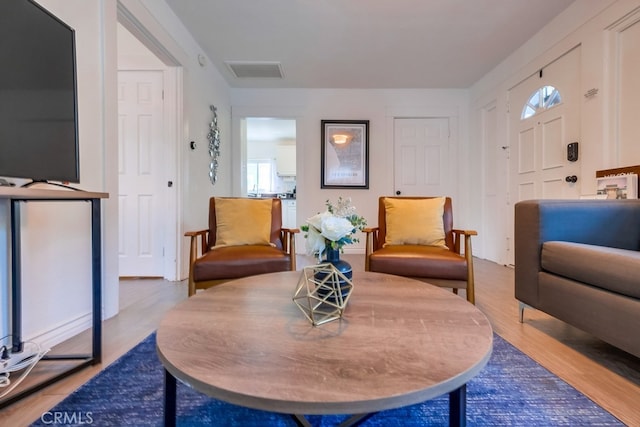 sitting room with hardwood / wood-style flooring