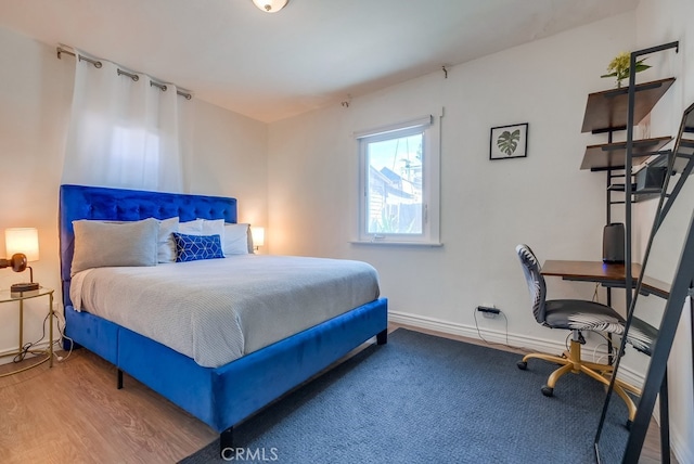 bedroom with wood-type flooring