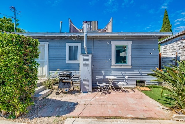 back of property with a patio