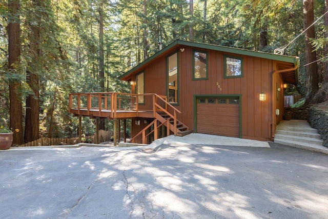 view of front of property with a wooden deck and a garage