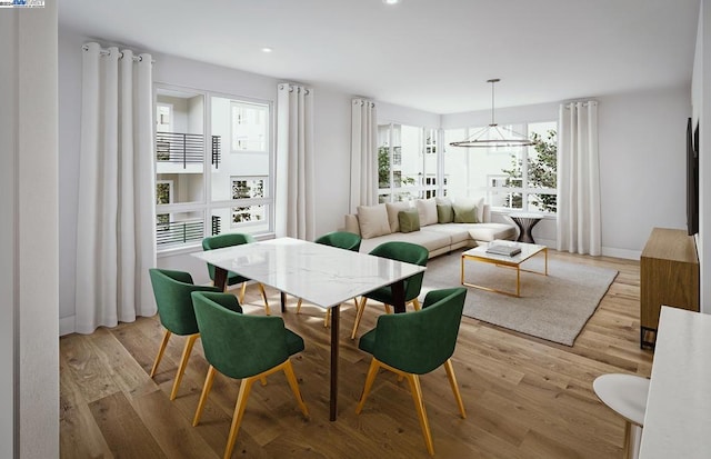 dining room featuring a chandelier and light wood-type flooring