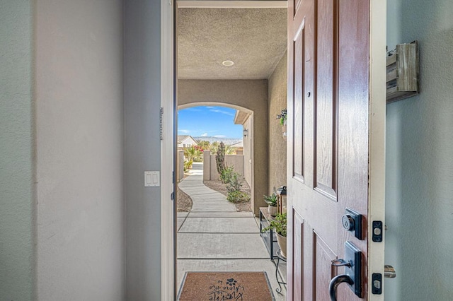 foyer entrance with a textured ceiling