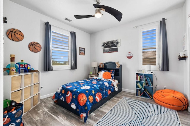 bedroom with hardwood / wood-style flooring and ceiling fan