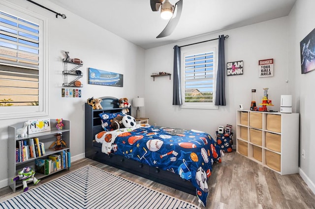 bedroom with wood-type flooring and ceiling fan