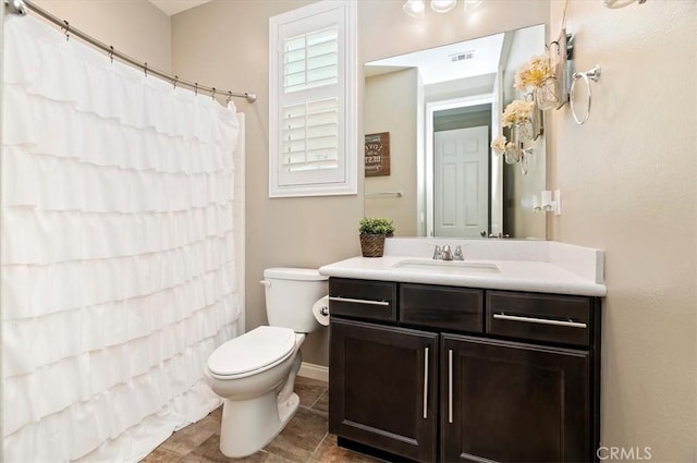 bathroom with toilet and vanity