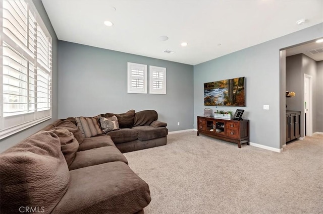 carpeted living room with a healthy amount of sunlight