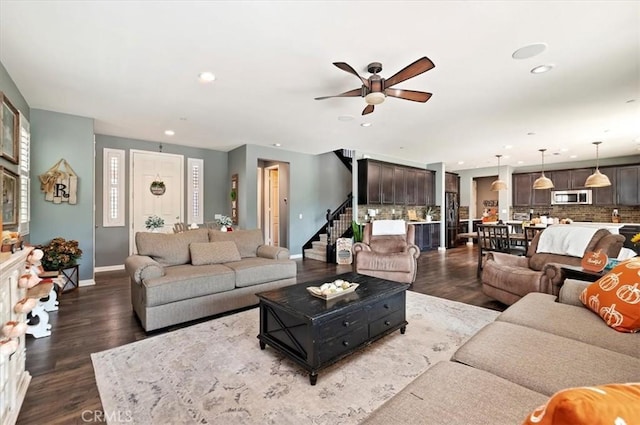 living room with ceiling fan and dark hardwood / wood-style floors