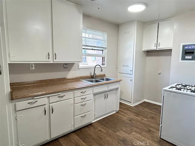 kitchen featuring white range, dark hardwood / wood-style floors, sink, and white cabinetry