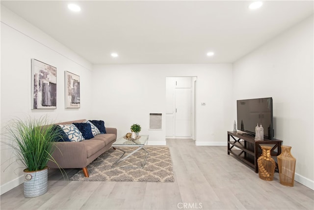 living room featuring heating unit and light wood-type flooring