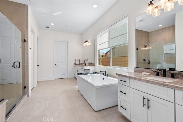 bathroom featuring tile patterned flooring, shower with separate bathtub, and vanity