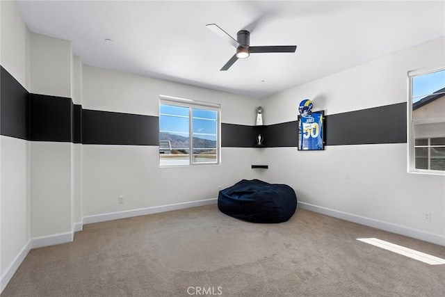 unfurnished room featuring carpet and ceiling fan