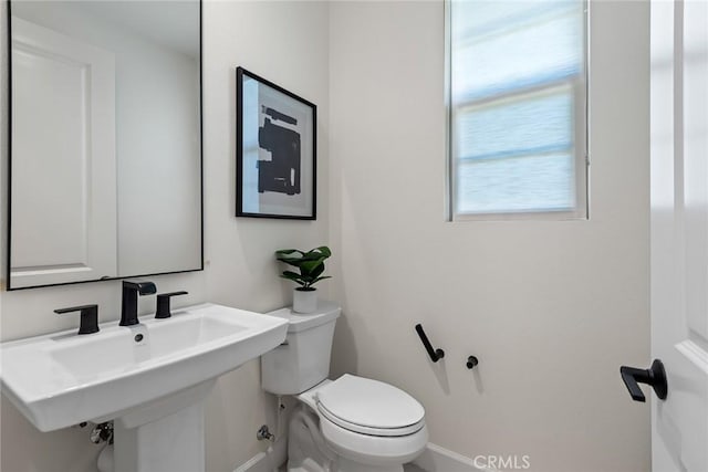 bathroom featuring toilet and sink