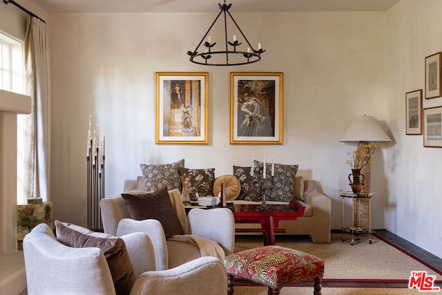 carpeted living room with an inviting chandelier