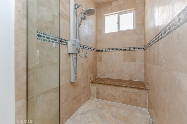 bathroom with tiled shower