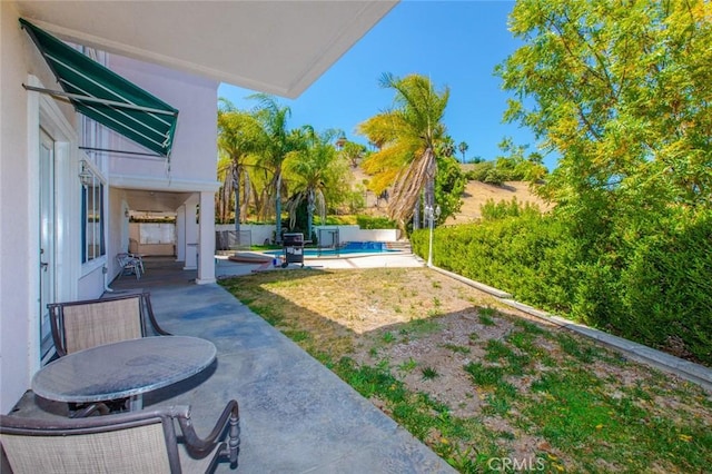 view of yard with a patio and a pool