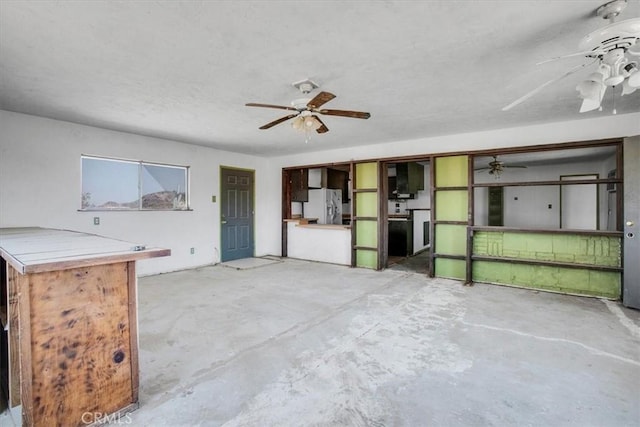 unfurnished living room with concrete flooring