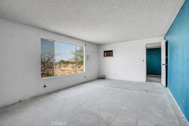 empty room featuring a textured ceiling