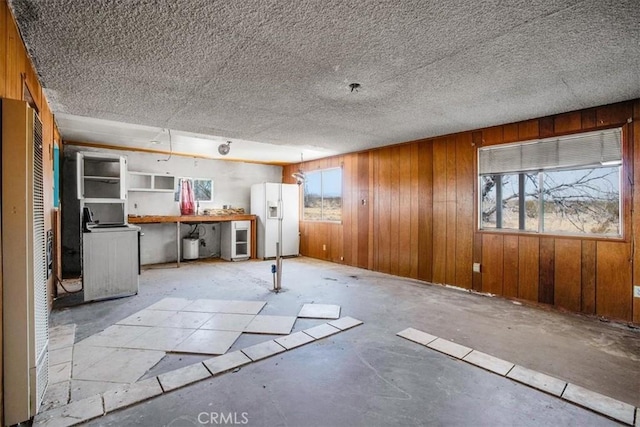 miscellaneous room featuring a workshop area, wooden walls, wine cooler, and washer / clothes dryer