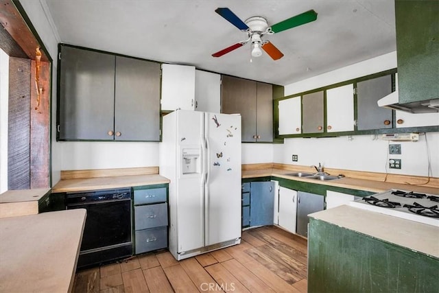 kitchen with white appliances, ventilation hood, ceiling fan, sink, and light hardwood / wood-style floors