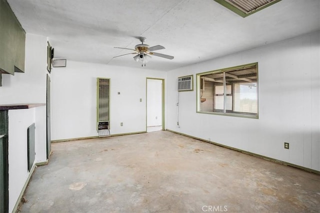 unfurnished living room with ceiling fan and a wall unit AC