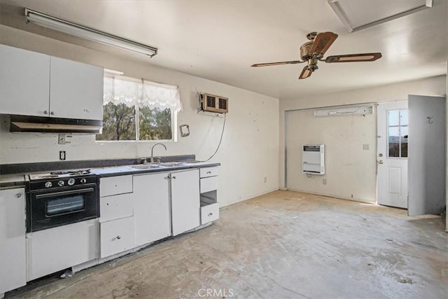 kitchen featuring white cabinets, heating unit, a wealth of natural light, and sink