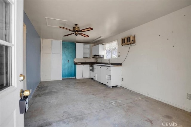 kitchen with ceiling fan, white cabinetry, and sink