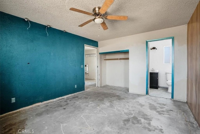 unfurnished bedroom featuring ensuite bath, ceiling fan, a closet, and a textured ceiling