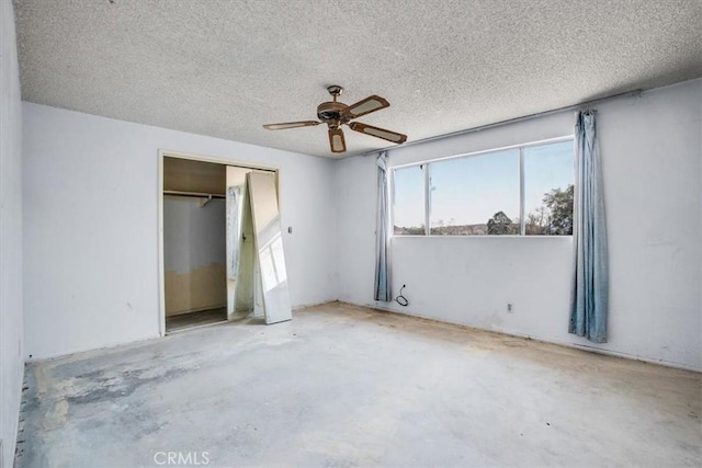 unfurnished bedroom with ceiling fan, a closet, concrete flooring, and a textured ceiling