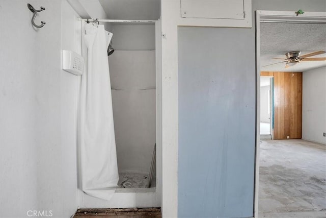 bathroom with ceiling fan, walk in shower, and concrete floors