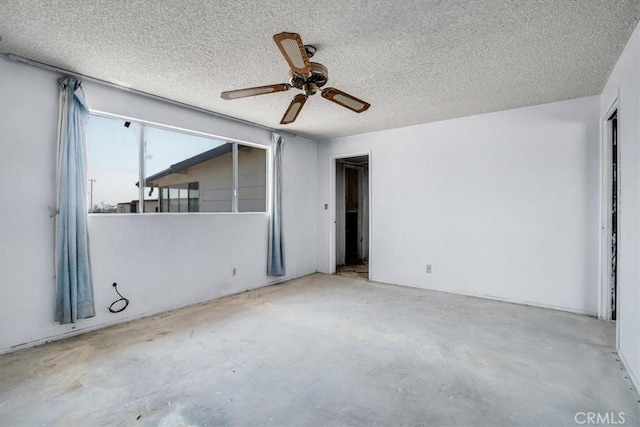 empty room featuring a textured ceiling and ceiling fan