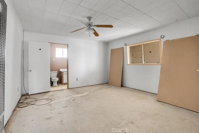 unfurnished bedroom with ensuite bath and ceiling fan