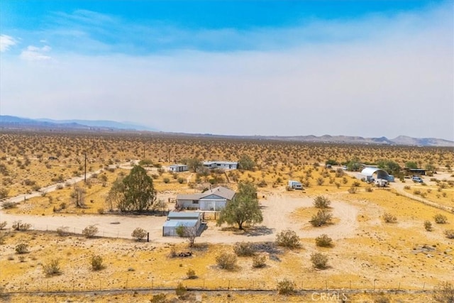 birds eye view of property with a mountain view and a rural view