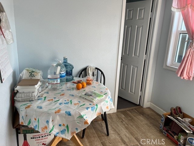 dining space featuring wood-type flooring