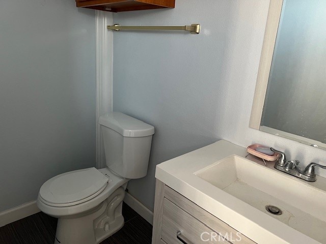 bathroom featuring vanity, toilet, and tile patterned floors