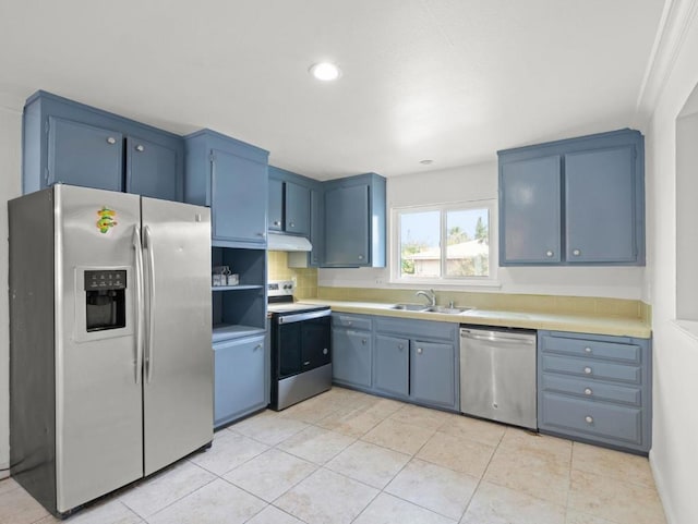 kitchen featuring light tile patterned floors, blue cabinets, sink, and stainless steel appliances