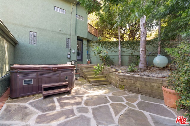 view of patio / terrace featuring a hot tub