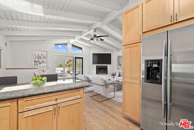 kitchen featuring lofted ceiling with beams, light wood-type flooring, stainless steel fridge with ice dispenser, light brown cabinets, and ceiling fan