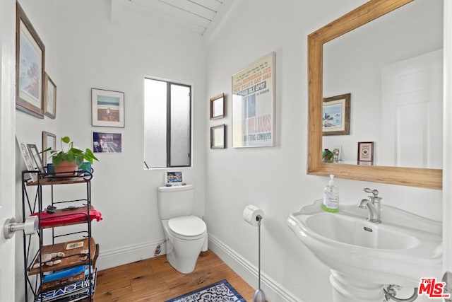 bathroom featuring hardwood / wood-style floors, toilet, and sink